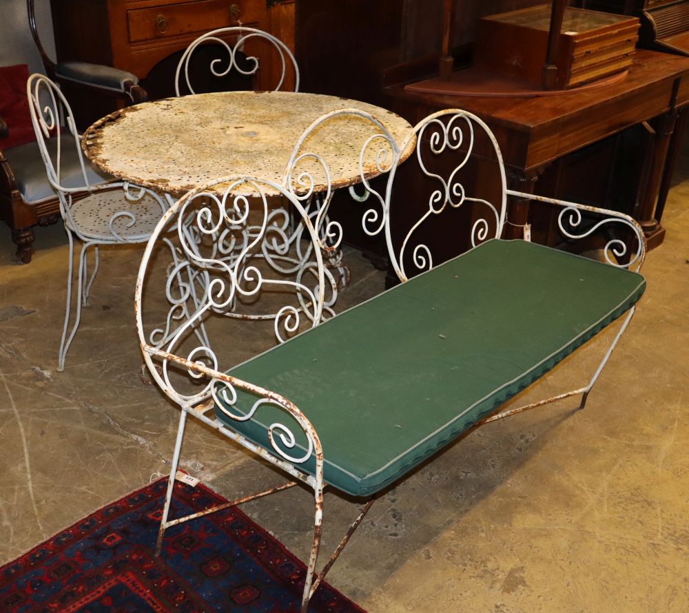 A circular metal garden table, a pair of matching chairs and a bench seat, bench W.130cm, D.56cm, H.89cm